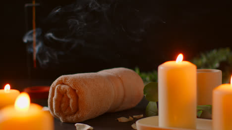 Still-Life-Of-Lit-Candles-With-Green-Plant-Incense-Stick-And-Soft-Towels-Against-Dark-Background-As-Part-Of-Relaxing-Spa-Day-Decor-4